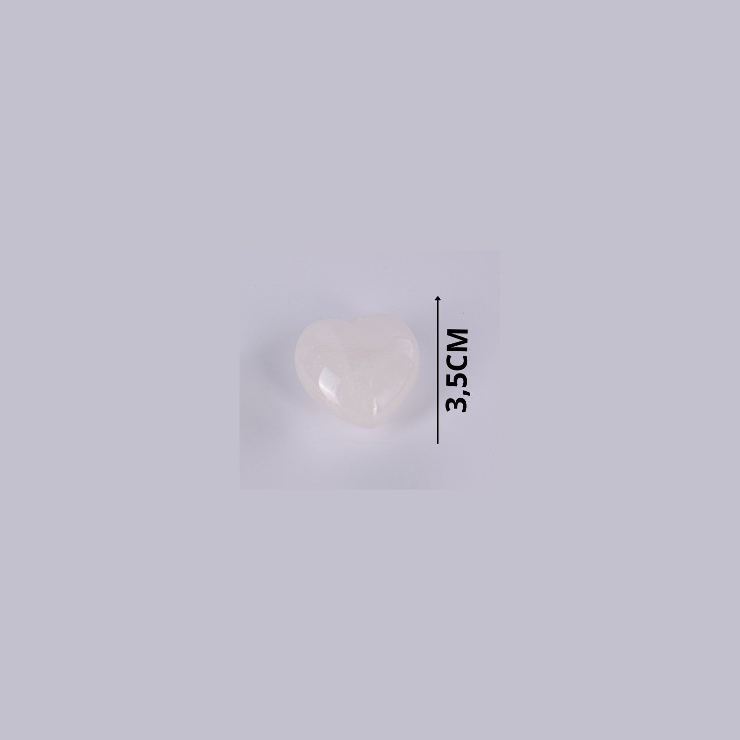 Guía de tamaño del corazón de Cuarzo Blanco natural indicando 3,5 cm de altura. Piedra semipreciosa pulida y suave.